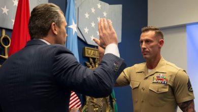 Veteran who lost both of his legs in combat reenlists in the Marine Corps