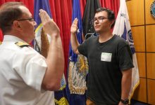 Navy captain gives oath of enlistment to son on last day of service